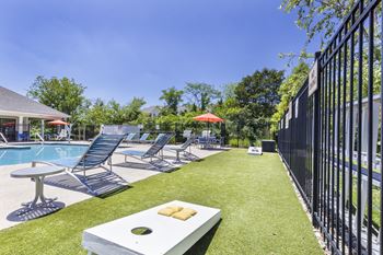 A poolside area with lounge chairs and a table.